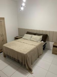 a bedroom with a bed with a blanket on it at Praia do Frances-Riviera do Frances casa 37 in Marechal Deodoro +44 photos