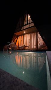 a house with a swimming pool in the night at Chader Bari Beach Resort, Cox's Bazar in Cox's Bazar