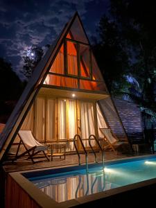 a small house with a pool in front of it at Chader Bari Beach Resort, Cox's Bazar in Cox's Bazar