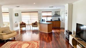 a large living room with a kitchen and a living room at Wagon Holiday Home in Broadwater