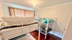 a bedroom with two bunk beds in a room at Wagon Holiday Home in Broadwater
