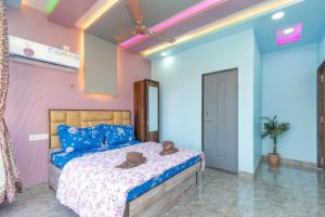 a bedroom with a bed with two hats on it at Jalsa Bungalow in Malavli