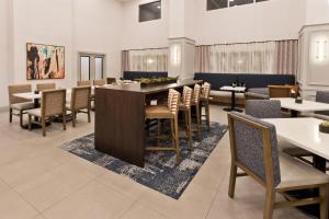 a dining room with chairs and a large table and tables at Hampton Inn & Suites Lanett/West Point in Lanett