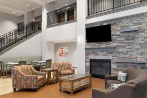 a lobby with a fireplace and a flat screen tv at Hampton Inn & Suites Boise-Meridian in Meridian