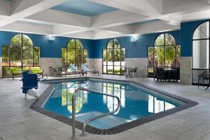 a pool in a room with blue walls and windows at Hampton Inn & Suites Boise-Meridian in Meridian