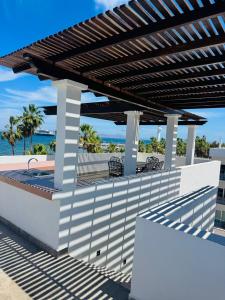 a wooden pergola on the side of a building at BAJA MÍA in Loreto