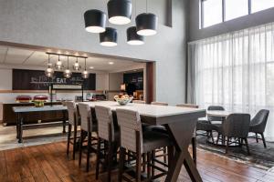 a kitchen and dining room with a table and chairs at Hampton Inn & Suites West Bend in West Bend