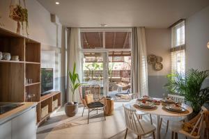 a kitchen with a table and chairs in a room at Ninemia Shore Retreat in Stalis in Stalís