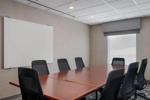a conference room with a wooden table and chairs at Hampton Inn & Suites West Bend in West Bend +23 photos