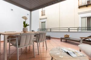 a patio with a table and chairs on a balcony at EOS Gaeta in Gaeta +37 photos