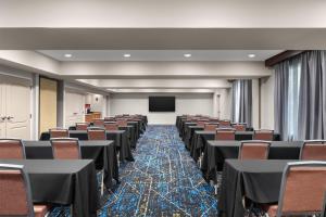 a conference room with tables and chairs and a screen at Hampton Inn & Suites Fresno in Fresno +29 photos