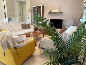 a living room with a couch and a table at Eri's House in Chrysoupolis