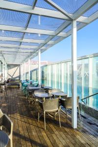 a restaurant with tables and chairs on a deck at Hotel Terrado Cavancha in Iquique