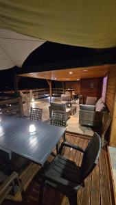 a patio with a table and chairs and a couch at Sole d'Oro in San-Nicolao