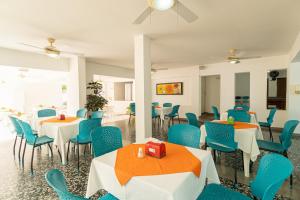 a dining room with tables and blue chairs at Casa Serena Hotel Boutique in Melgar