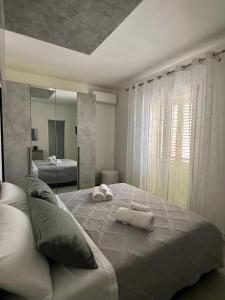 a bedroom with a large bed with towels on it at U Zu Ciccio in Terrasini