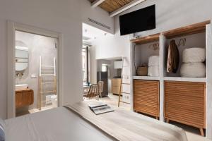 a bedroom with a bed and a tv on a wall at EOS Gaeta in Gaeta