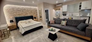 a living room with a couch and a bed at Sea Salt Apartments in Samos