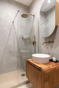 a bathroom with a sink and a glass shower at EOS Gaeta in Gaeta
