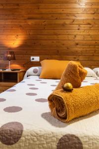 a bedroom with a bed with a teddy bear on it at Alojamiento Rural Cosorios in Cangas de Onís +52 photos
