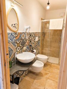 a bathroom with a sink and a toilet and a shower at Paradice in Baunei in Baunei +14 photos