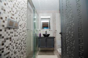 a bathroom with a sink and a glass shower at Relais Des Nomades in Tinerhir +101 photos