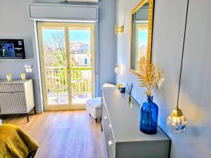 a living room with a blue vase on a table at SuiteLina in Giardini Naxos