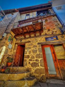 a stone building with a door and a balcony at APARTAMENTOS La Colmena APT- 2 - AT-CC-00248 in Gata