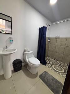 a bathroom with a toilet and a shower and a sink at Centro Turístico Las Palmitas in Muelle del Arenal +17 photos