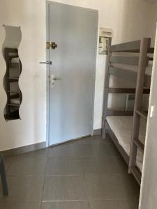 a door to a room with a bunk bed at SETE studio cabine face mer in Rémire-Camp