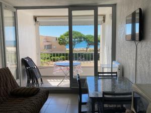 a living room with a table and a view of the ocean at SETE studio cabine face mer in Rémire-Camp