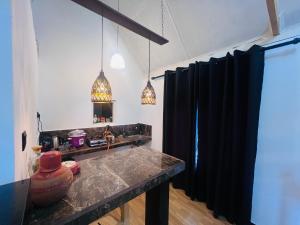 a kitchen with black curtains and a counter top at Kekulama Eco Cabana Galle in Galle +21 photos