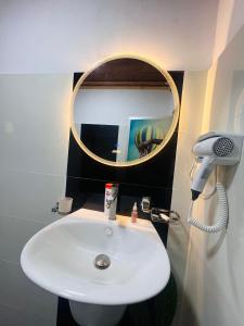 a bathroom with a white sink and a mirror at Kekulama Eco Cabana Galle in Galle