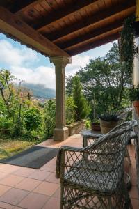a bench sitting under a pergola on a patio at Alojamiento Rural Cosorios in Cangas de Onís