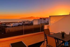 a balcony with a table and a view of the ocean at Arthouse Sea View - Acquamarina e Zaffiro in Puerto del Carmen