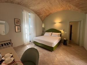 a bedroom with a large bed in a room at Palazzo Brunamonti Boutique Hotel in Bevagna