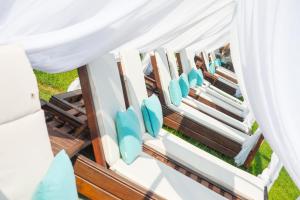 a row of chairs under a marquee with white curtains at Tarsanas Studios in Limenas