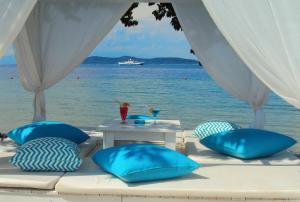 a table with blue pillows and a view of the ocean at Tarsanas Studios in Limenas