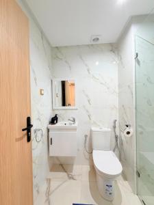 a bathroom with a toilet and a sink and a shower at Stay with US in Agadir +30 photos