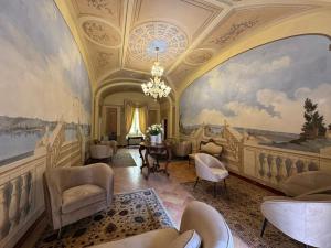 a living room with a large painting on the wall at Palazzo Brunamonti Boutique Hotel in Bevagna