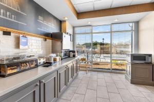 a kitchen with a counter and a large window at Hampton Inn Guntersville in Guntersville