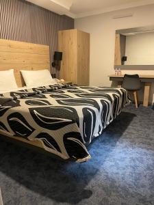 a bedroom with a bed with a black and white blanket at Hotel Monaco in Mexico City +50 photos