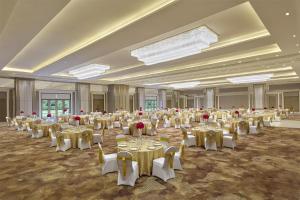 a banquet hall with tables and chairs in a room at DoubleTree by Hilton Agra in Agra +46 photos
