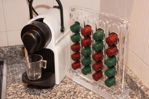 a coffee maker with a glass holder on a counter at Lucero Dos Catedrales in Zaragoza