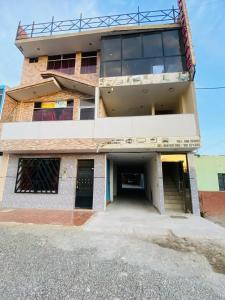 an old building with a parking garage in front of it at Hospedaje De Joce in Nazca
