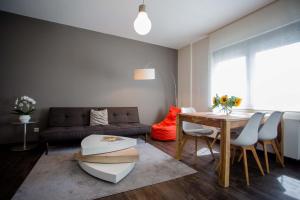a living room with a couch and a table at Boardinghouse Offenbach Service Apartments in Offenbach