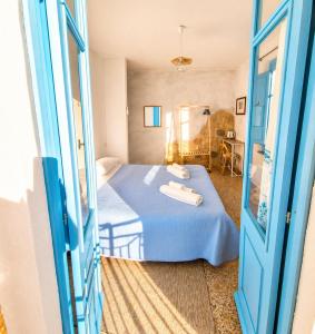 a bedroom with a blue bed and a blue door at Paradice in Baunei in Baunei