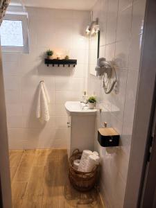 a white bathroom with a sink and a mirror at Lake House Mierzyn in Mierzyn +19 photos