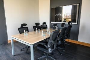 a conference room with a wooden table and black chairs at Hotel Terrado Cavancha in Iquique +35 photos