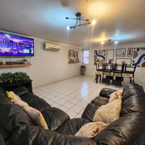 a living room with two leather couches and a flat screen tv at Casa Morada in San Felipe